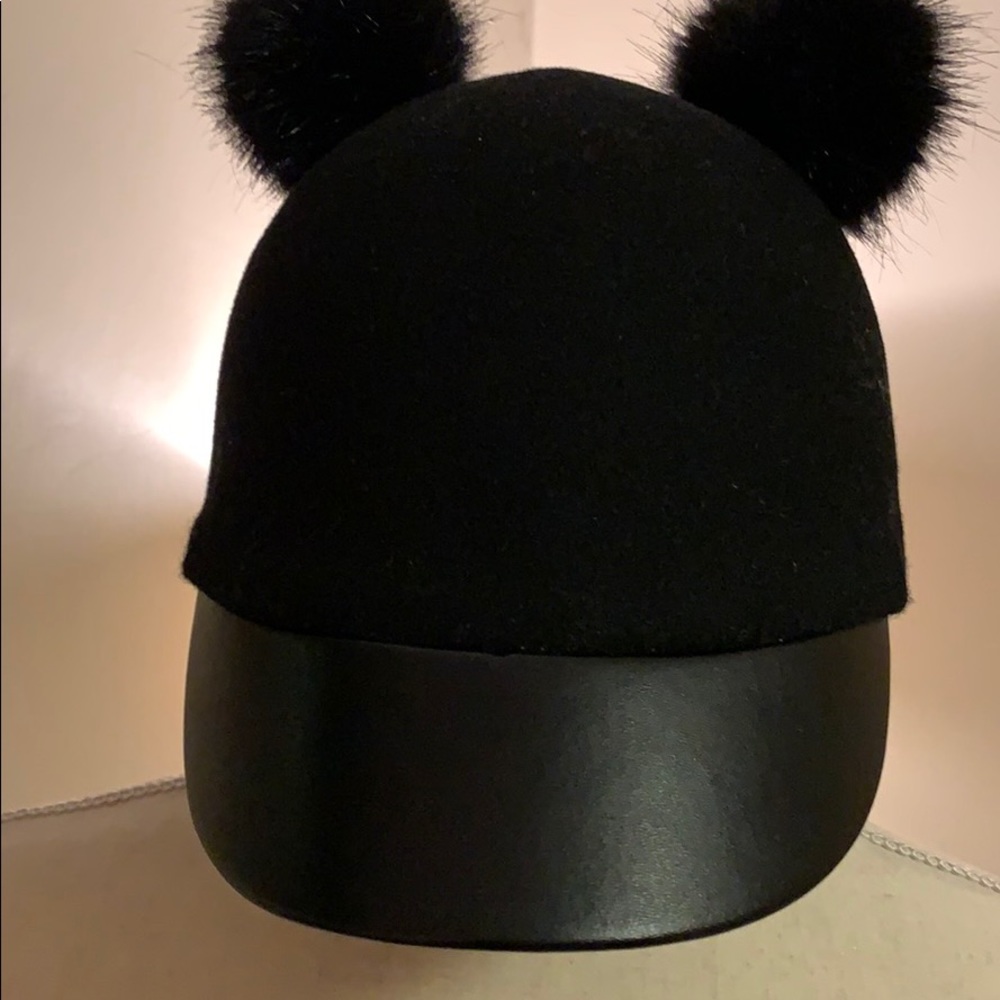 WOOL FURY CAP WITH TWO FURY PUFF BALLS.